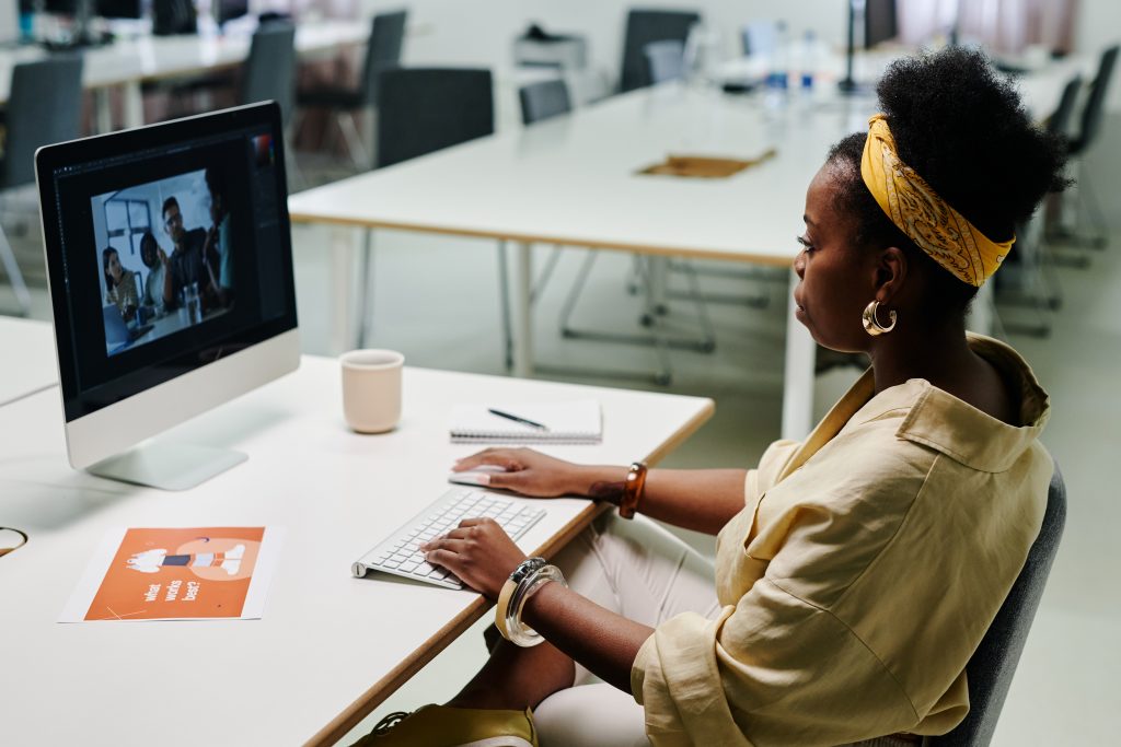 woman sat at computer video editing